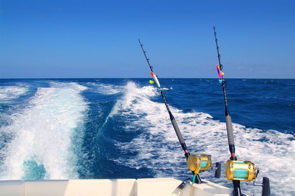 Fishing boat traveling in the open ocean to get to the deep waters and the fishing spot for striped marlin, skipjack tuna and a yellow fin.