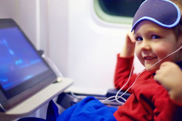 Child watching his cartoons on an airplane trip.