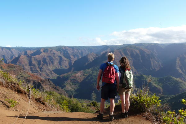 Couple overlooking the Waimea Canyon as part of their Hawaii honeymoon
