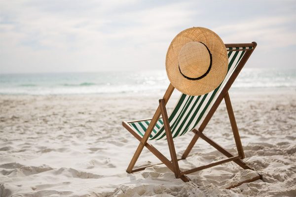 Sun hat kept on beach chair.