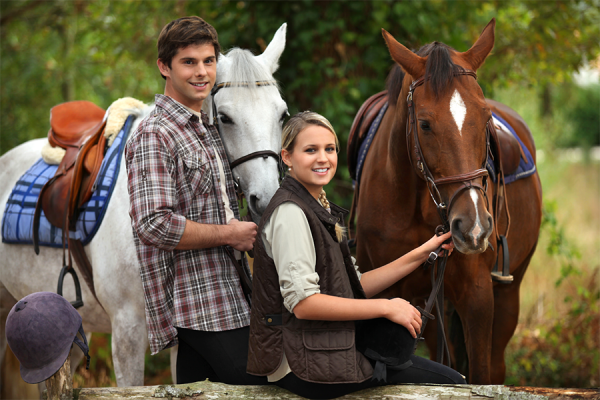 Young couple preparing for horseback riding at Princeville resort ranch