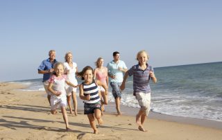 Kauai family reunion photo of family running down the beach