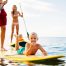 Family enjoying Kauai Paddle Boarding adventure on a tranquil ocean - North Shore bliss